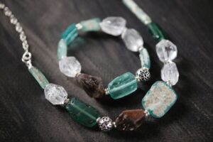Close-up of a beautiful custom gemstone necklace and bracelet set.
